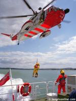 ID 8002 A UK Coastguard Sikorsky S-61N MkII air-sea rescue helicopter approaches overhead before lifting a 